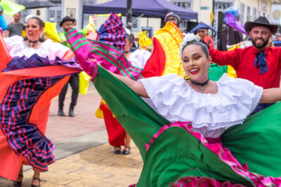 Dancers performing a traditional Costa Rican folk dance in vibrant attire