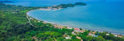 Coastal view of Playa Potrero highlighting calm waters and walkable layout