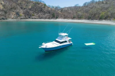 Private yacht near remote beach under blue sky